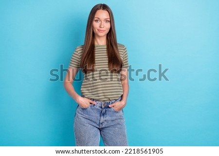 Portrait photo of young attractive gorgeous nice woman wear khaki striped t-shirt hands pockets confident business isolated on blue color background