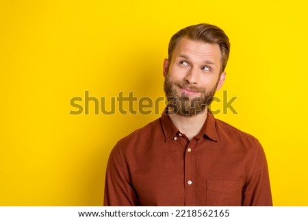 Photo of handsome thoughtful positive man with blond beard dressed burgundy shirt look empty space isolated on yellow color background Royalty-Free Stock Photo #2218562165