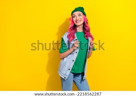 Photo of cheerful positive extravagant lady dressed jeans modern clothes interested look empty space isolated on yellow color background Royalty-Free Stock Photo #2218562287