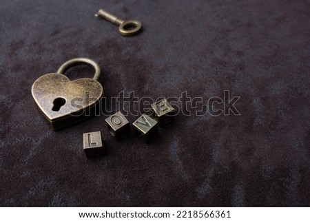 Love shaped padlock, key and love wording on black background