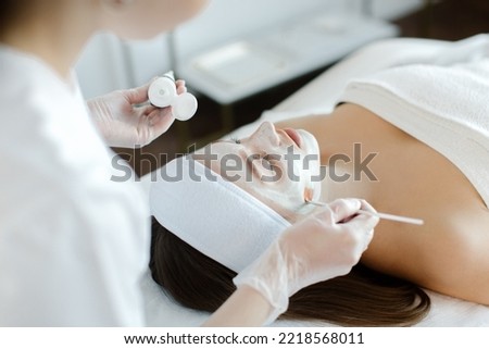Close up of cosmetologist do beauty face procedures or treatment to woman client in aesthetic medicine clinic. Cosmetology concept. High quality photo