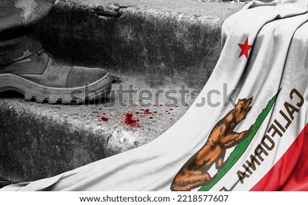 The leg of the military stands on the step next to the flag of State of California, the concept of military conflict