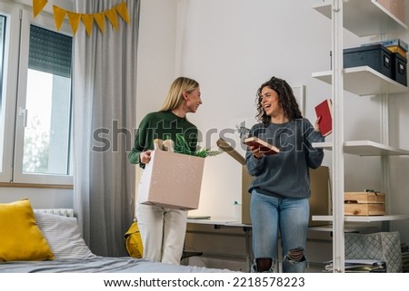 female college student move in dorm. they are talking in the room Royalty-Free Stock Photo #2218578223