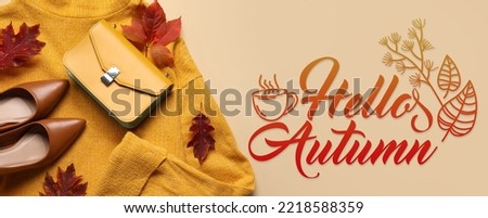 Stylish woman's clothes and accessories with text HELLO AUTUMN on beige background