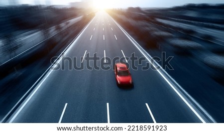 Highway with single red car, motion blur