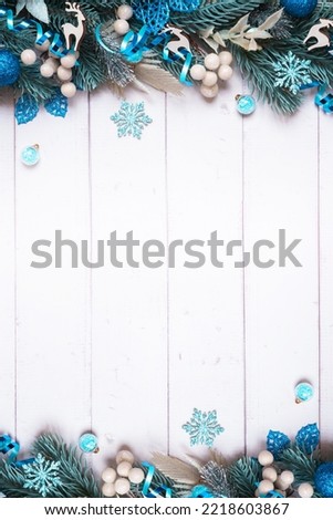 Christmas background made from pine tree, berries and festive decorations top view. Christmas flat lay.