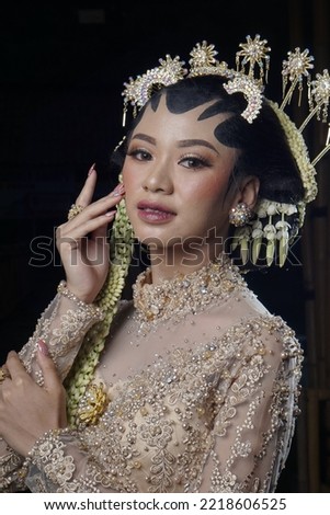 Beautiful model, wearing makeup and Javanese Indonesian wedding dress.