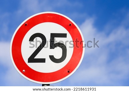 a road sign shows speed limit of 25 mph.