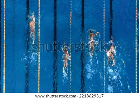 group of swimmers training in an outdoor pool top view Royalty-Free Stock Photo #2218629317