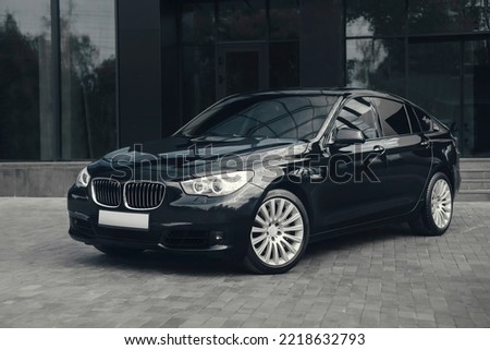 Black luxury business class car, with beautiful wheels, large chrome grille.