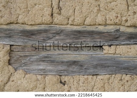 Croatia, October 20,2022 : Facade of mud and straw on old wooden house.
