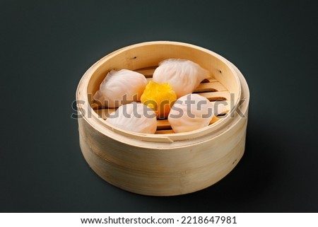 Delicious soft and tasty prawn Dim Sum. A Chinese traditional dish, served in a bamboo basket. Light breakfast or lunch option. Royalty-Free Stock Photo #2218647981