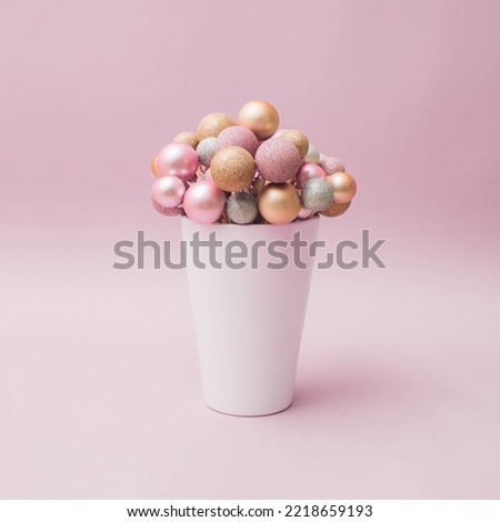 New Year's and Christmas decorations in the form of flowers. White vase on pink pastel background.