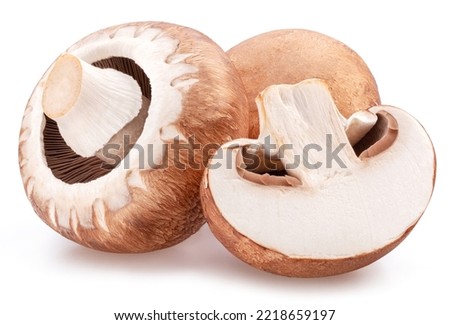 Brown cap champignons with slice of champignon mushroom isolated on white background. Close-up. Royalty-Free Stock Photo #2218659197