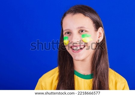 young girl, soccer fan from Brazil. close-up photo smiling.