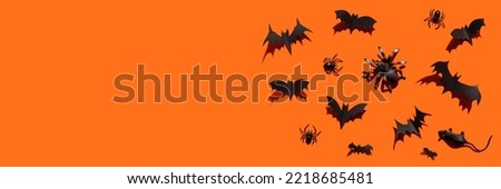 Halloween banner black paper bats, spiders, mouse with hard shadows on orange background copy space.Halloween decoration with your own hands.