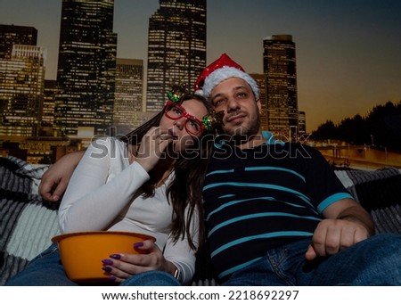 Woman and man watch movie at home, eat popcorn. Selective focus. Picture for website about family, movies, Christmas.
