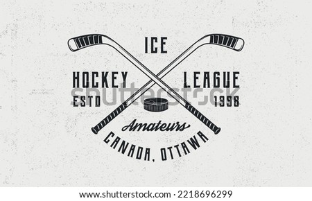 Ice Hockey league logo, poster. Vintage hockey emblem with crossed hockey cues and puck icon. Logo template for team, club, league, tournament. Vector illustration Royalty-Free Stock Photo #2218696299