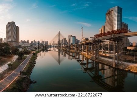 View of Pinheiros River With Modern Buildings Alongside and Famous Octavio Frias de Oliveira Bridge in Sao Paulo City Royalty-Free Stock Photo #2218722077