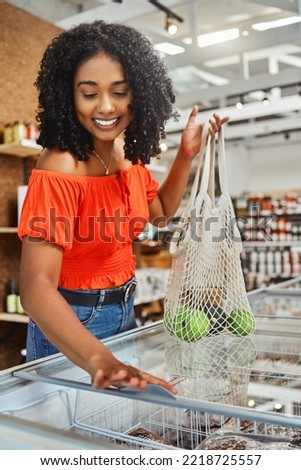 Shopping, grocery store and customer black woman with product price check in freezer and happy with discount, sale or promotion discount. Groceries, supermarket woman with green retail food choice Royalty-Free Stock Photo #2218725557