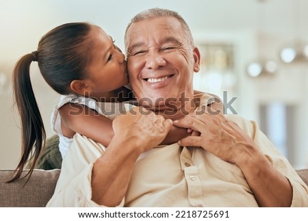 Happy, grandfather and little girl kiss with hug for love and care in family bonding time or generations at home. Portrait of grandpa with smile in happiness for hugging, loving and caring grandchild