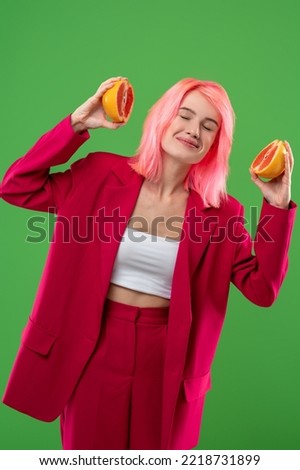 Cute joyous girl enjoying the fresh citrus fruit aroma