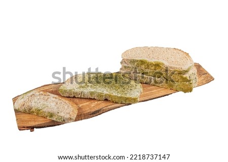 Waste The picture of a moldy bread. Rotten and uneatable. Isolated on white background. Green mildew on a stale bread. Surface of moldy bread. Moldy fungus on rotten bread.