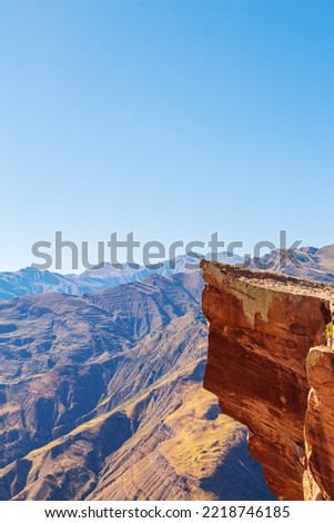 Extreme ledge in the rock Troll tongue. View of the Caucasus Range, Dagestan. Royalty-Free Stock Photo #2218746185