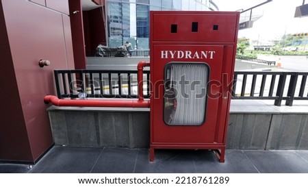 Fire protection cabinet box with fire hydrant and hose. It's in the mall shopping center