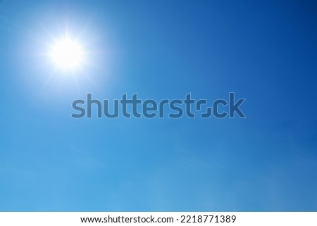 bright sun shines on clear blue sky. Royalty-Free Stock Photo #2218771389