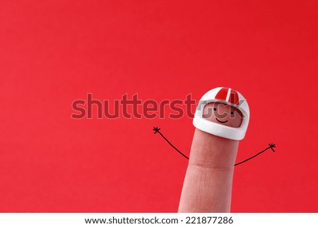 Race driver - Funny painted figure painted on finger with helmet on red background with space for text