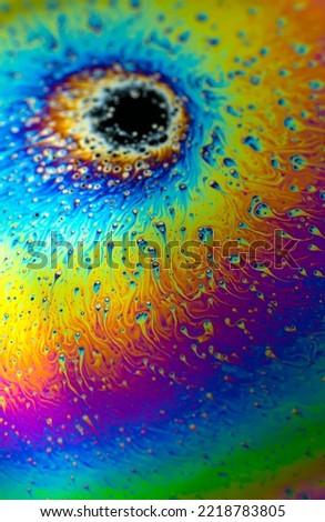 Photo of iridescent surface of soapy water. Space abstract colorful background for your screensaver. High quality photo
