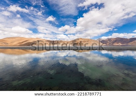 Landscape scene of Pangong Lake in autumn season with reflection of mountain and blue sky at Leh, Ladakh, India