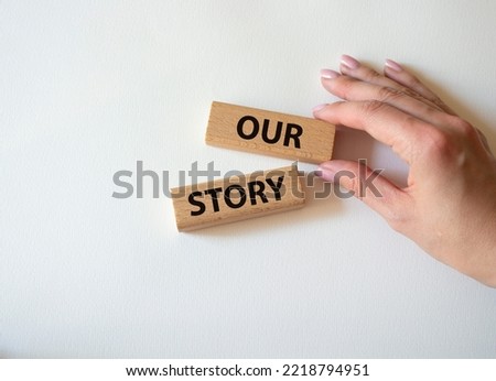 Our story symbol. Wooden blocks with words Our story Beautiful white background. Businessman hand. Business and Our story concept. Copy space. Royalty-Free Stock Photo #2218794951