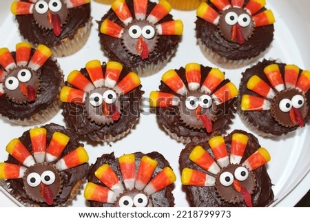 Home baked Thanksgiving cupcakes decorated with candy turkeys. 