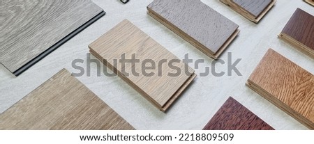 samples of interior wooden flooring material consists oak, walnut, ash, douglasfir engineering (or laminate) flooring, ash and oak vinyl tile. perspective view of selected materials on board. Royalty-Free Stock Photo #2218809509