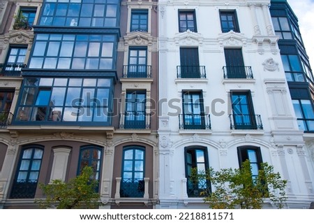 facades of old residential buildings. Windows, balconies, stone, brick, concrete.