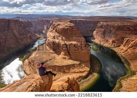 The famous horse shoe bend at Glen Canyon, with the Colorado River at the bottom surrounded by steep orange-red rocks, Arizona Royalty-Free Stock Photo #2218823615