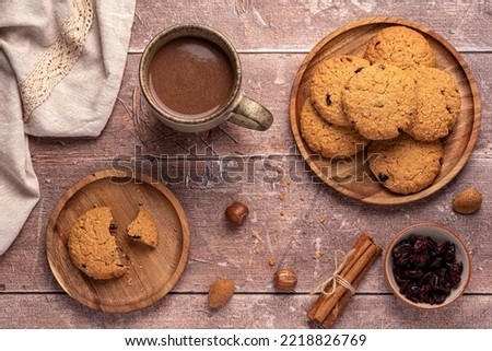 Food photography of oatmeal cookies, biscuits,  nuts, dried cranberries, cinnamon, chocolate, cocoa