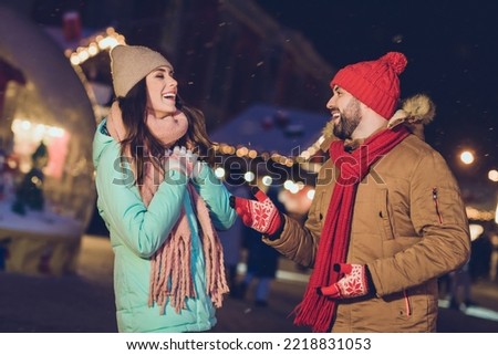 Profile photo of enjoy couple laugh wear cap jacket scarf gloves outside on x-mas eve