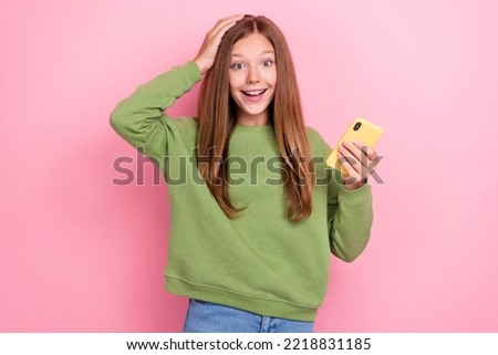 Portrait of impressed girl green sweatshirt hold smartphone arm on head unbelievable unexpected sale isolated on pink color background Royalty-Free Stock Photo #2218831185