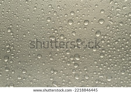 Raindrops on the chrome-plated metal surface. Rain on a metallic silver background.
