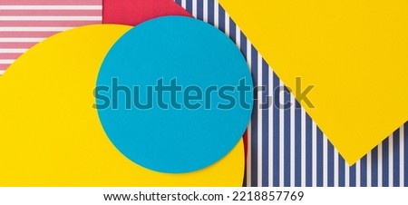 Abstract trendy fashion colored papers texture background in memphis geometry style. Yellow, red, blue, white colors. Geometric shapes and striped lines. Top view, flat lay Royalty-Free Stock Photo #2218857769