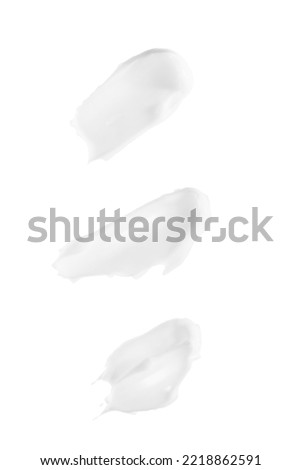Smears of white cream isolated on white background