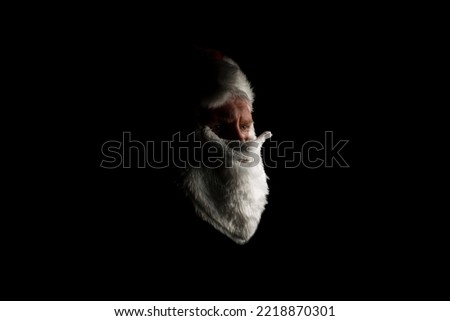 A fake Santa giving a serious look just off camera.