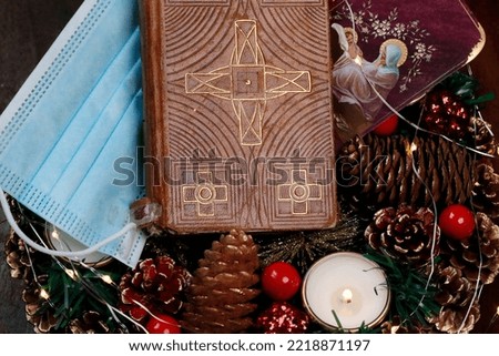 Advent wreath, bible and surgical mask. Christmas composition. 