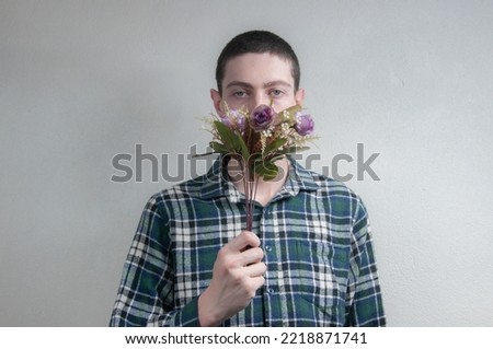  Beautiful young man holding flowers