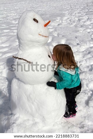 Cute little girl with snowman