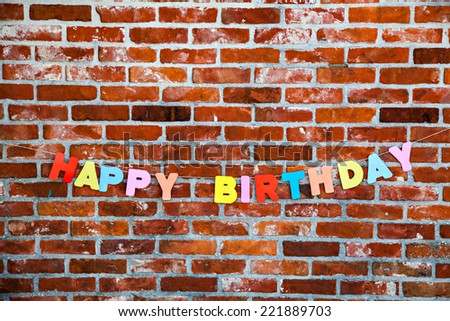 Inscription Happy Birthday on brick wall