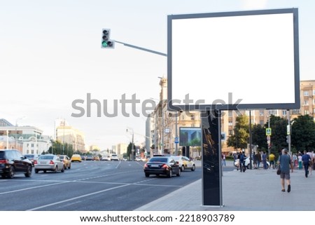 Blank horizontal large billboard in the city. Cars on the road, pedestrians on the sidewalk. Mock-up.